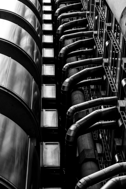 Black and white view of the industrial looking Lloyds building, London
